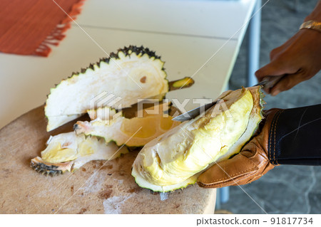Durian Seller are showing how to open and explain informations and details to audiences about type of durain on the lunch table. Durian Seller are showing how to open and explain informations and details to audiences about type of durain on the lunch table. 91817734