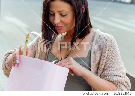 Young beautiful woman smiling going to the shops with eco bags 91821946