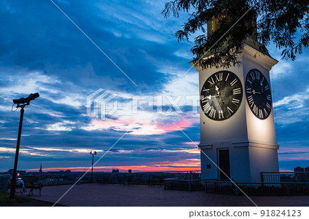 Illuminated clock tower at Petrovaradin Fortress in Novi Sad, Serbia 91824123