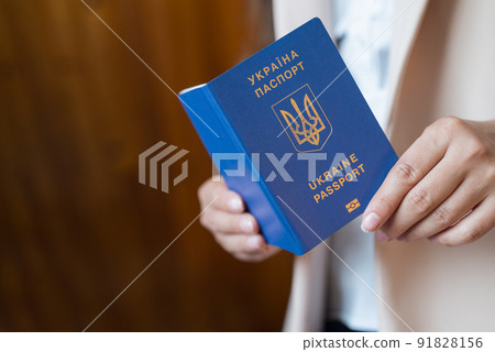 a girl holds a passport of ukraine in her hands 91828156