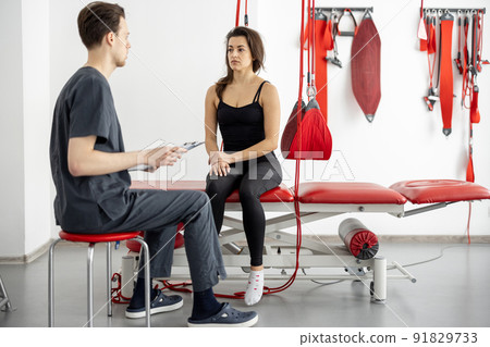 Woman having consultation with physiotherapist at rehabilitation office Woman having consultation with physiotherapist at rehabilitation office 91829733