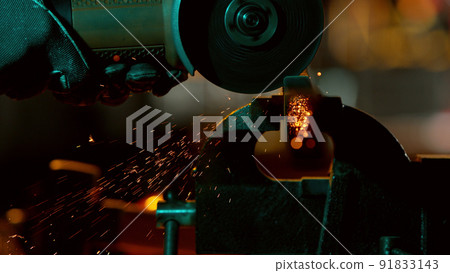 Detail of industry worker cutting steel pipe with flex saw 91833143