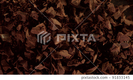 Freeze motion of flying group of raw chocolate pieces. Freeze motion of flying group of raw chocolate pieces. 91833145