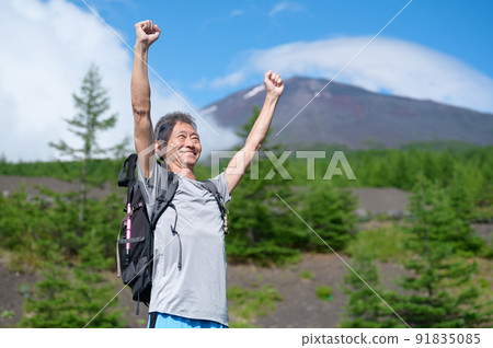 Climbers raising their hands with Mt. Fuji in the background 91835085