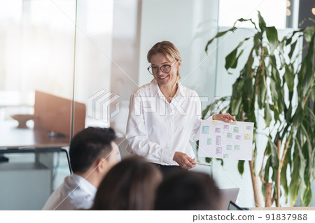 Businessman Gives Report to His Business Colleagues, Pointing at the Results Showing Statistics 91837988