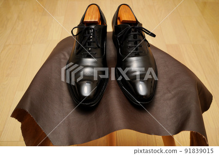 Black straight tip leather shoes on a stool Black straight tip leather shoes on a stool 91839015