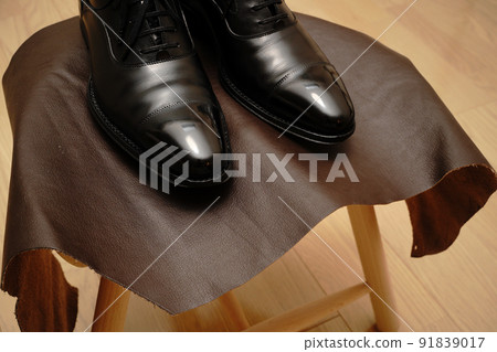 Black straight tip leather shoes on a stool Black straight tip leather shoes on a stool 91839017