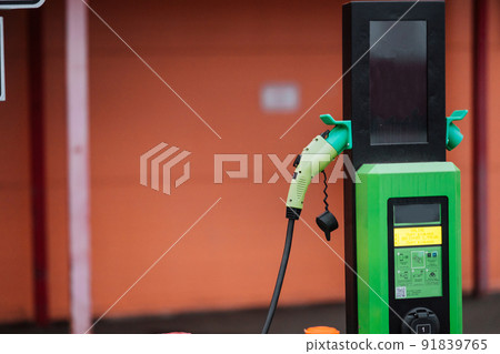 Close up power cord for electric car. Green station 91839765