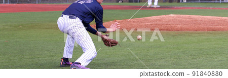 Baseball third baseman making a play on the infield 91840880