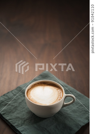 Fresh flat white with latte art in ceramic cup on wood table Fresh flat white with latte art in ceramic cup on wood table 91842110