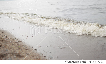 closeup shot of waves rolling on a beach on Baltic Sea 91842532