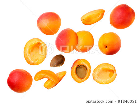 Set of ripe apricots and pieces are flying on a white background. Isolated Set of ripe apricots and pieces are flying on a white background. Isolated 91846051