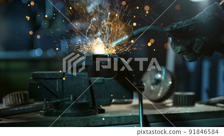 Freeze Motion of Working Welder in Workshop. Detail shot, low depth of focus. Freeze Motion of Working Welder in Workshop. Detail shot, low depth of focus. 91846584