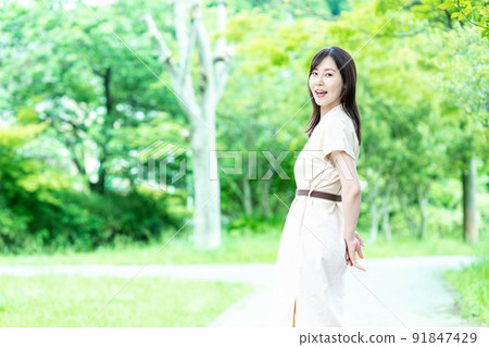 A woman strolling in the fresh green 91847429