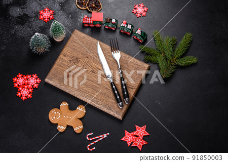 Christmas homemade gingerbread cookies, spices and cutting board on dark background Christmas homemade gingerbread cookies, spices and cutting board on dark background 91850003