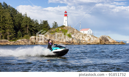 Adventurous Caucasian Woman on Sea-Doo riding in the Ocean Adventurous Caucasian Woman on Sea-Doo riding in the Ocean 91851732
