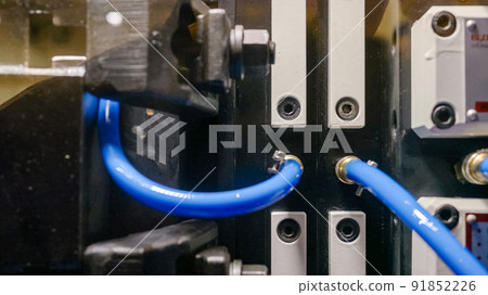 Close-up injection molding machine making blue forms. Close-up injection molding machine making blue forms. 91852226