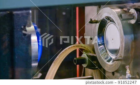 Close-up working metal industrial injection molding making machine. 91852247