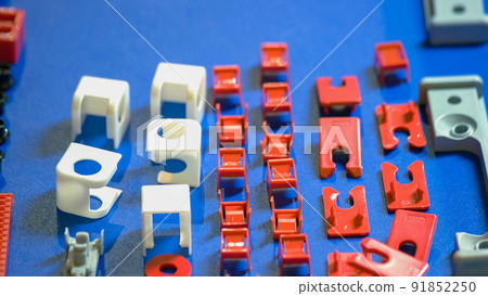 Many various colored plastic details on the blue desk Many various colored plastic details on the blue desk 91852250