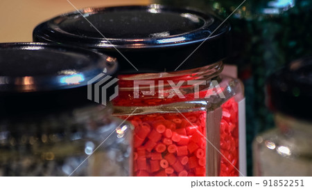Glass containers filled with colored cylinders. Glass containers filled with colored cylinders. 91852251