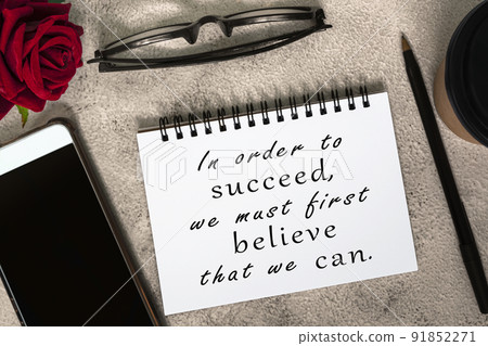 Motivational and inspirational quote on a note book on marble table. 91852271