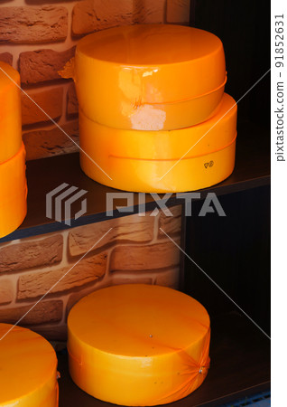 Cheese Heads on Shelves at the Food Market. Whole cheese wheels. Cheese Heads on Shelves at the Food Market. Whole cheese wheels. 91852631