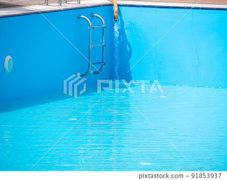 Pouring fresh water into swimming pool. Clear blue water refreshing disinfection purification, algae bacteria prevent. 91853937