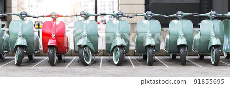Vintage moped scooter in row on a parking of the city. Vintage moped scooter in row on a parking of the city. 91855695