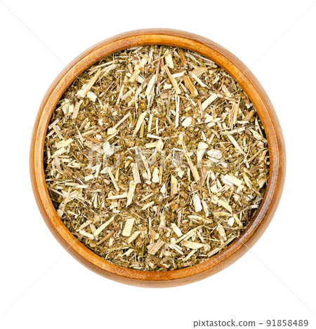 Sweet wormwood, dried herb, Artemisia annua in wooden bowl. The discovery of the plant extract artemisinin is a Nobel prize awarded medication used to treat malaria. Used in TCM as tea to treat fever. 91858489