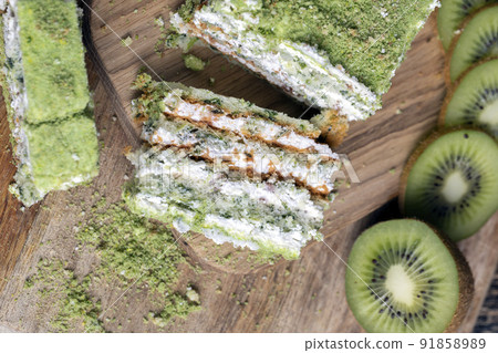 sliced green kiwi on a cutting board 91858989
