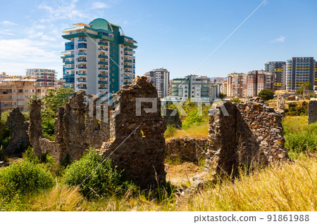 Naula Ancient City ruins among modern buildings of Mahmutlar Naula Ancient City ruins among modern buildings of Mahmutlar 91861988