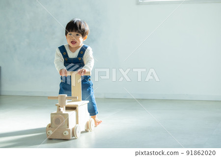 1 year old boy playing with a wheelbarrow 1 year old boy playing with a wheelbarrow 91862020