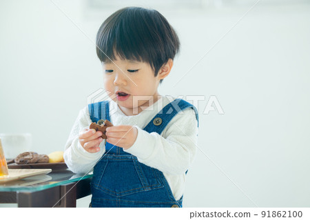 1 year old boy eating cookies 1 year old boy eating cookies 91862100