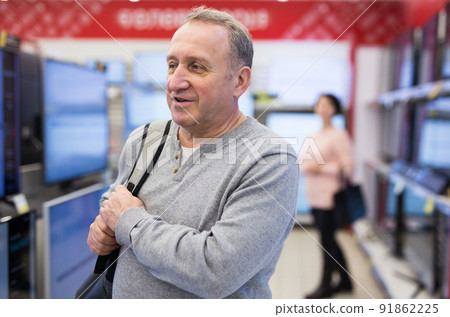 Portrait of a European man in the department with televisions Portrait of a European man in the department with televisions 91862225