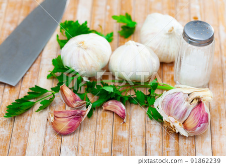 Garlic and parsley on the cutting board Garlic and parsley on the cutting board 91862239