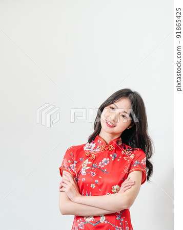 穿著傳統旗袍的美麗亞洲年輕女人站在白色背景前 91865425