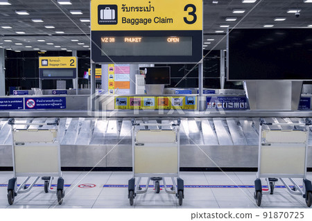 empty airport luggage trolleys or baggage carts at baggage claim  aria in arrival terminal at Suvarnabhumi airport on during covid or coronavirus pandemic. 91870725