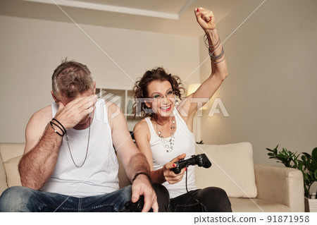 Couple Enjoying Playing Videogame 91871958