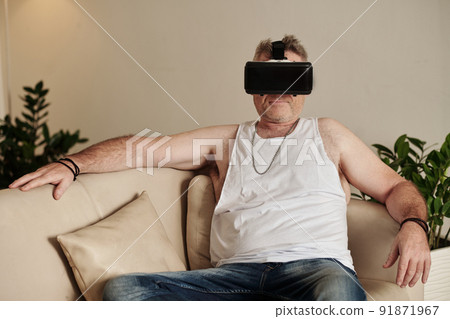 Man in VR headset Watchig Movie Man in VR headset Watchig Movie 91871967
