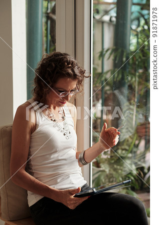 Woman Reading Article on NFT and Cryptocurrency 91871978