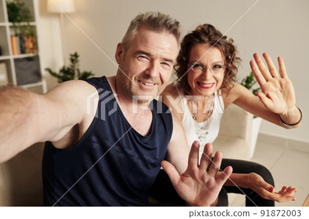 Happy Couple Waving at Camera 91872003