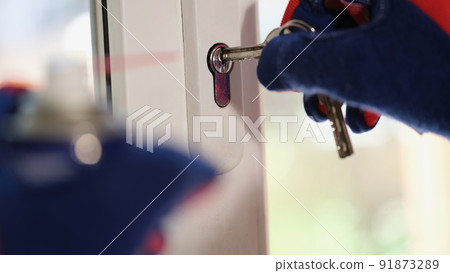 Repairman checking keys and lock of plastic window Repairman checking keys and lock of plastic window 91873289