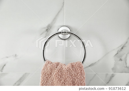 Holder with clean towel on light wall Holder with clean towel on light wall 91873612