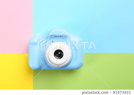 Light blue toy camera on color background, top view Light blue toy camera on color background, top view 91873833