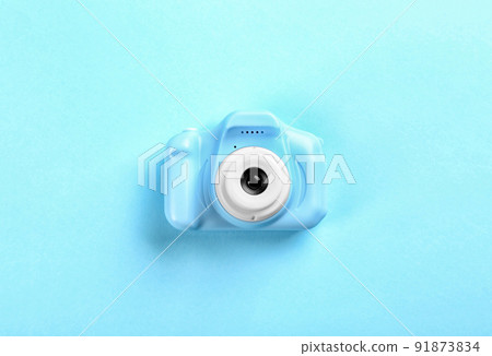 Toy camera on light blue background, top view Toy camera on light blue background, top view 91873834