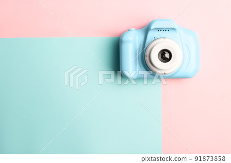 Light blue toy camera on color background, top view with space for text. Future photographer Light blue toy camera on color background, top view with space for text. Future photographer 91873858