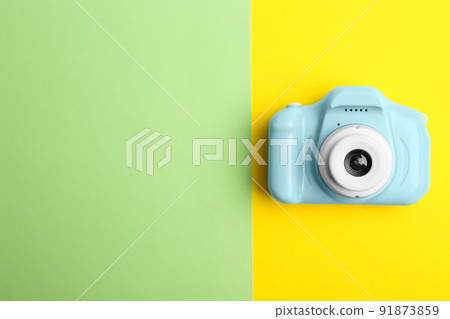 Light blue toy camera on color background, top view with space for text. Future photographer 91873859