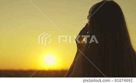 young girl runs across field sunset headphones. silhouette girl rays sunlight listens music. healthy image women health. morning run outdoors cardio. exercises weight loss. long-haired sun girl. young girl runs across field sunset headphones. silhouette girl rays sunlight listens music. healthy image women health. morning run outdoors cardio. exercises weight loss. long-haired sun girl. 91874091
