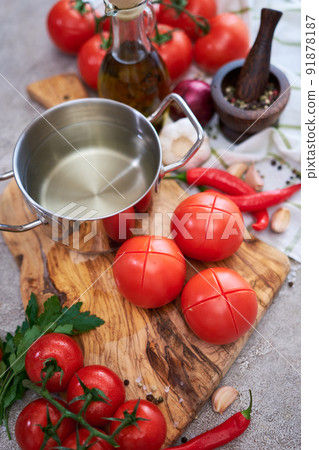 blanched tomatoes on wooden cutting board ready for peeling at domestic kitchen 91878187