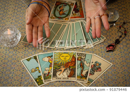 A person who fortune tells with a tarot card A person who fortune tells with a tarot card 91879446